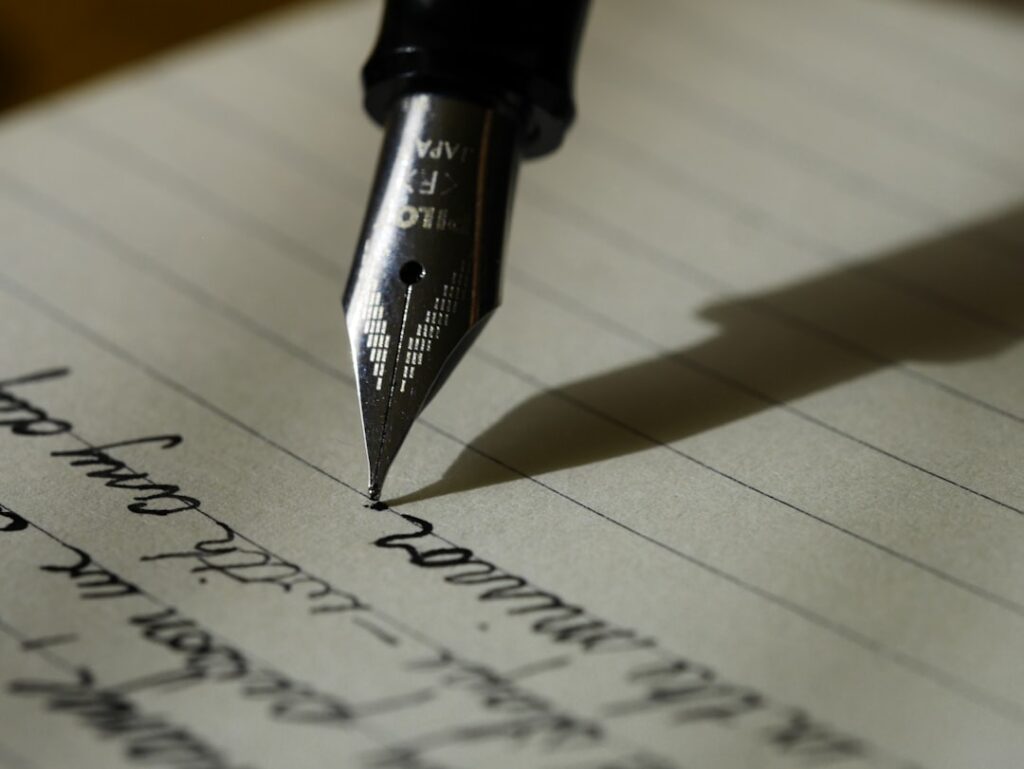 Person writing an about page story on a laptop