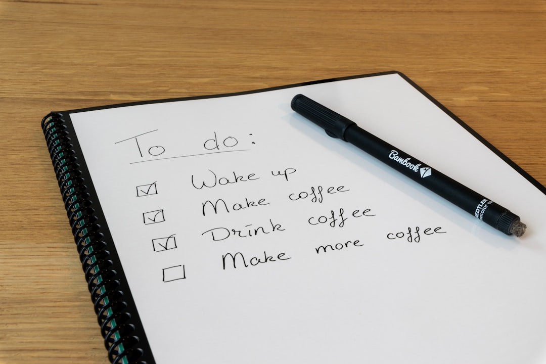 Notepad and pen representing writing out a services list for a Google Business Profile